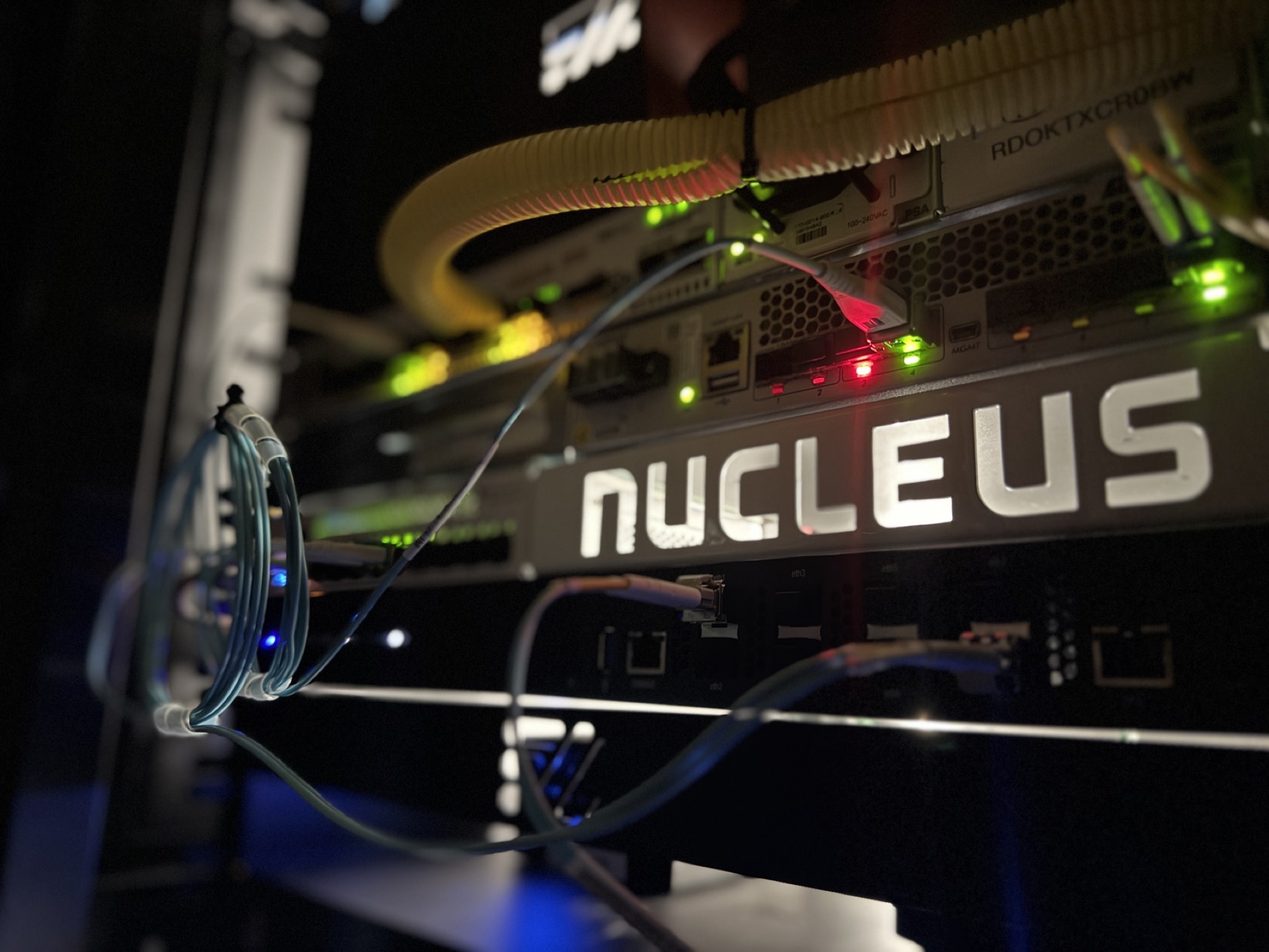 Nucleus branded CPE mounted in a customer rack with fiber cabling and active status LEDs